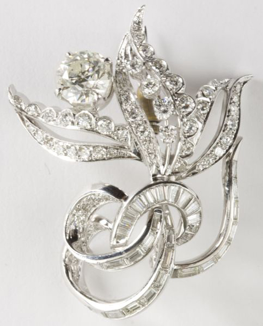 This stunning circa 1955 14kt white gold diamond brooch in a floral spray design realized $3,910.